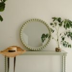 Bobbin Style round mirror with a wooden pale olive frame